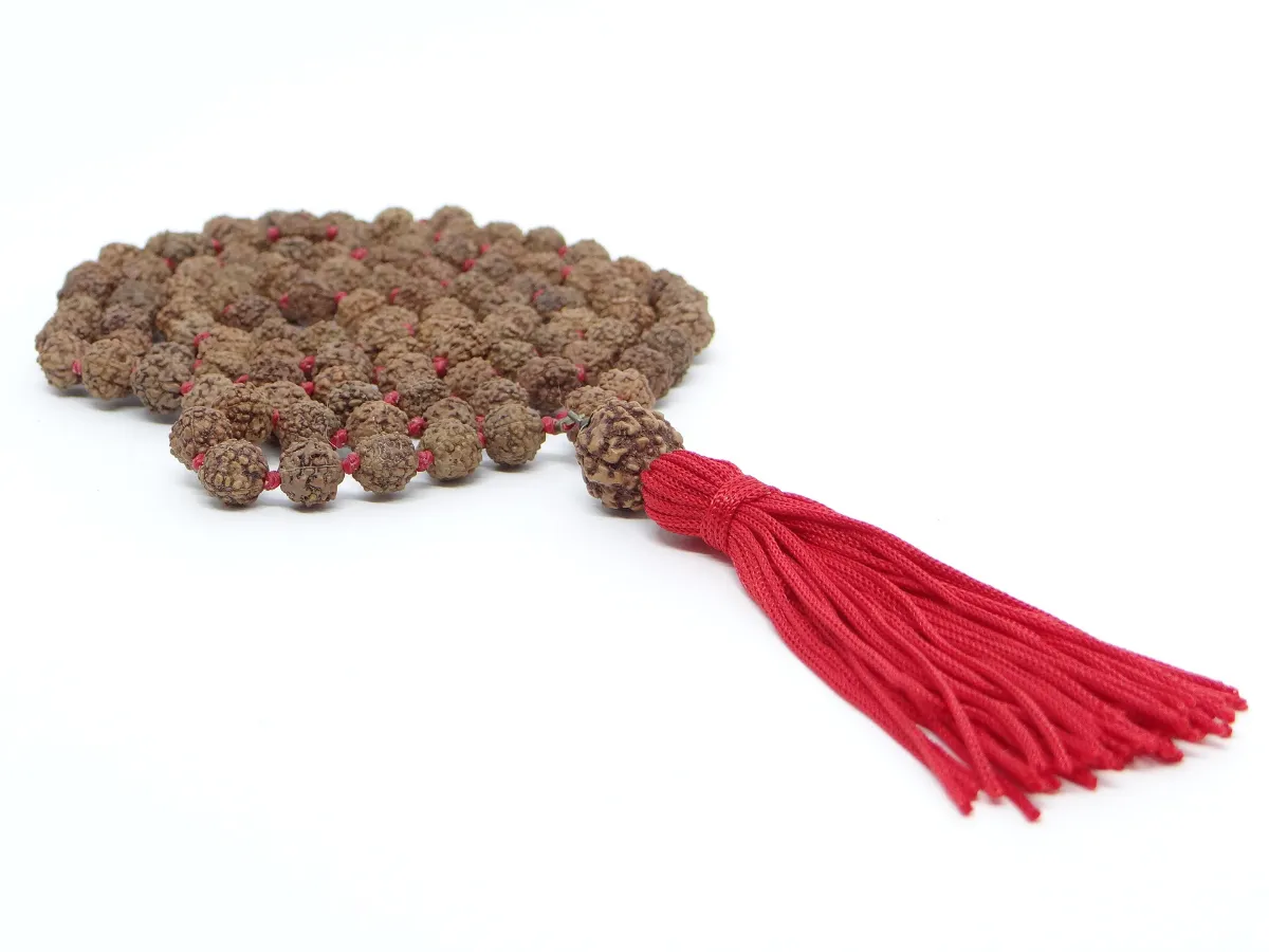 A rudraksha japa mala of natural beads knotted on red thread, finished with a red tassel