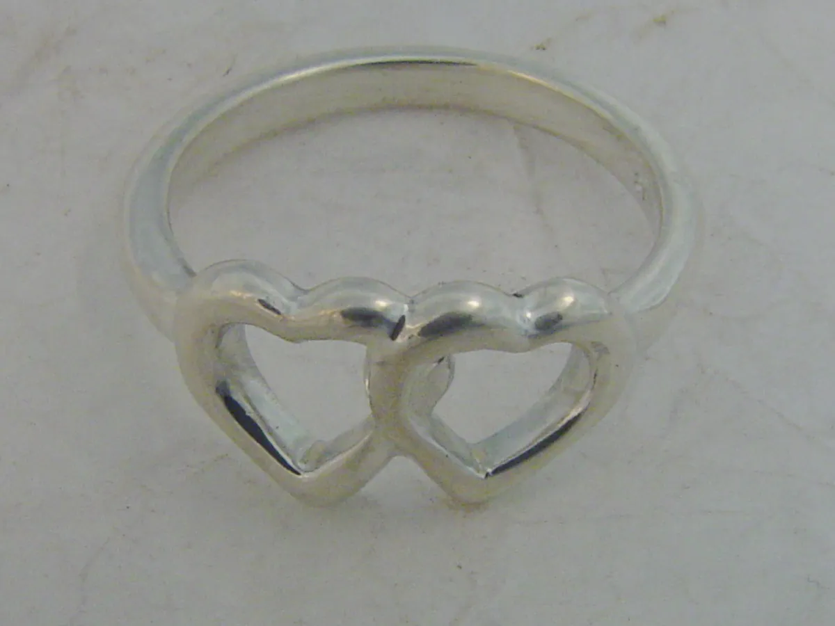 A sterling silver ring with two interlinked open hearts