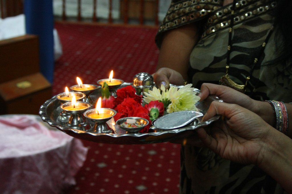 An aarti thali with lamps, flowers and offerings used in Hindu worship