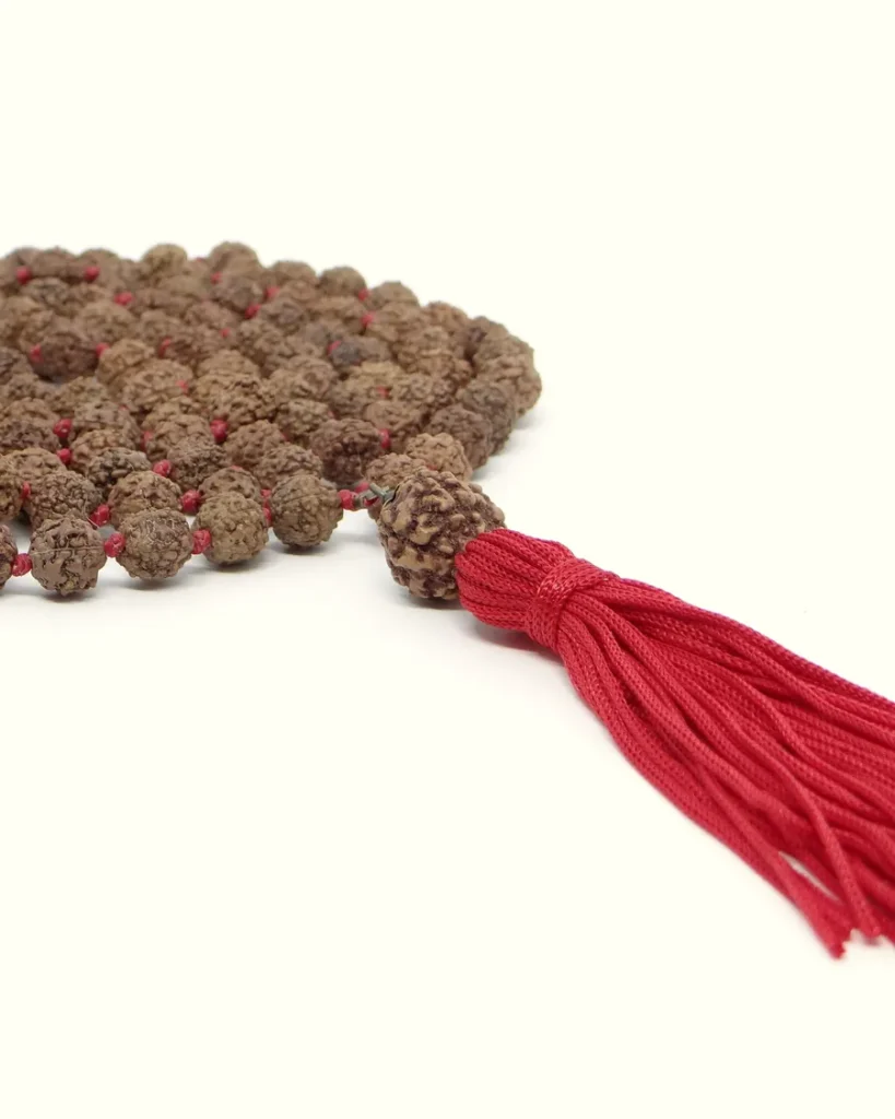 A traditional 108-bead rudraksha japa mala with a red tassel