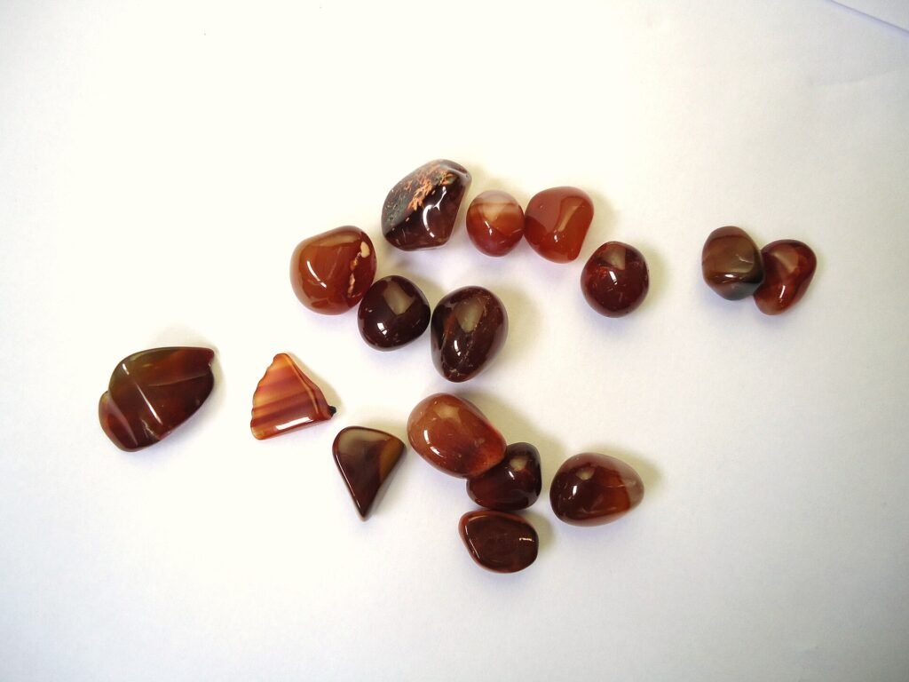Polished orange-red and reddish-brown carnelian pebbles