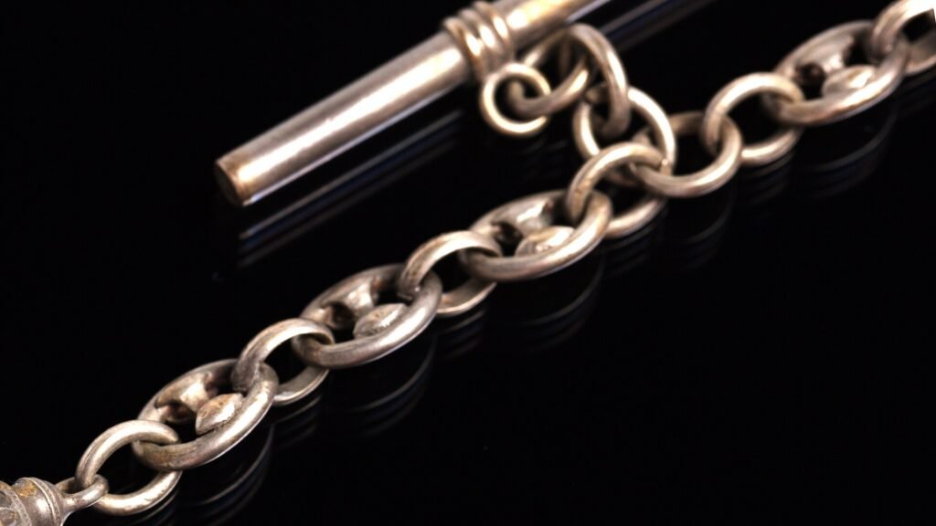 A silver fob watch chain with alternating oval links