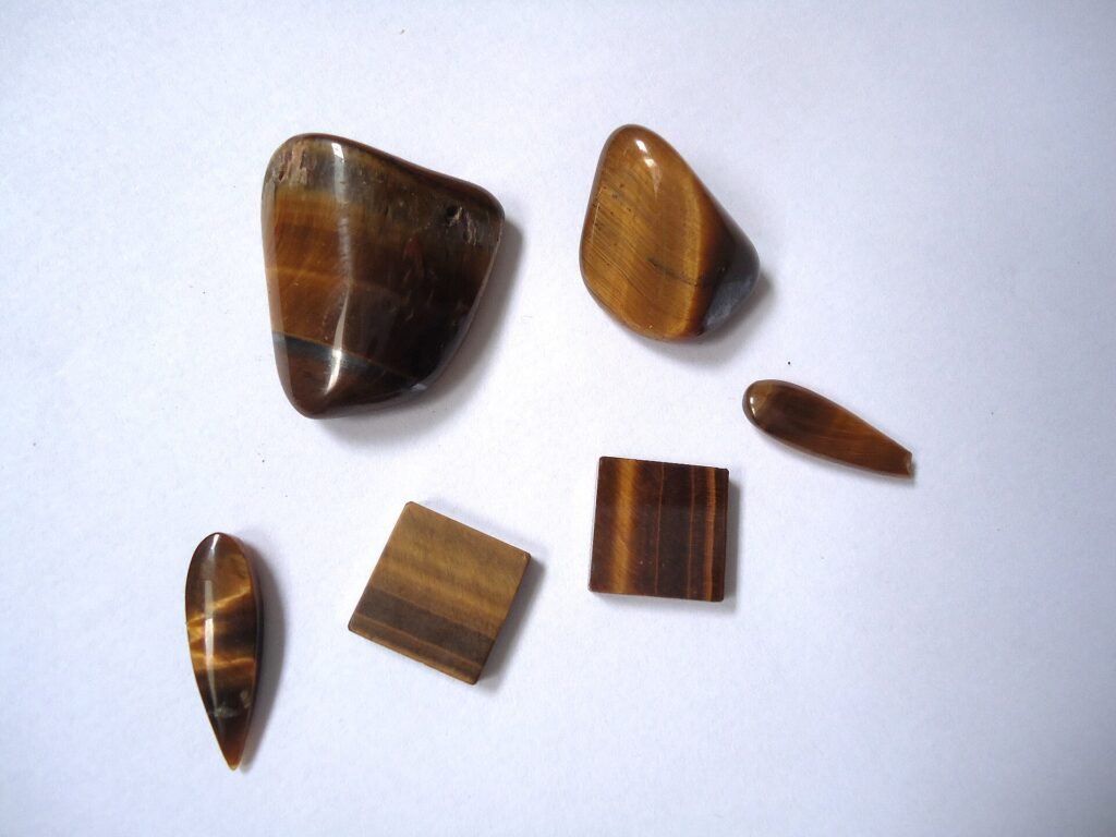 Polished golden-brown tiger's eye gems showing silky bands of light