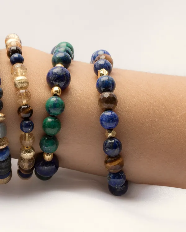 Stacked stone bead bracelets on a wrist